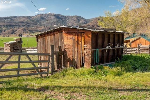 view of outbuilding featuring a mountain view and a rural view