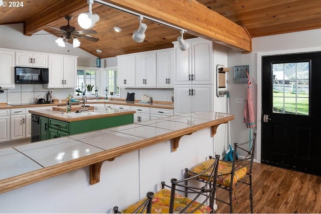 kitchen featuring wood ceiling, dark hardwood / wood-style floors, white cabinetry, vaulted ceiling with beams, and tile countertops