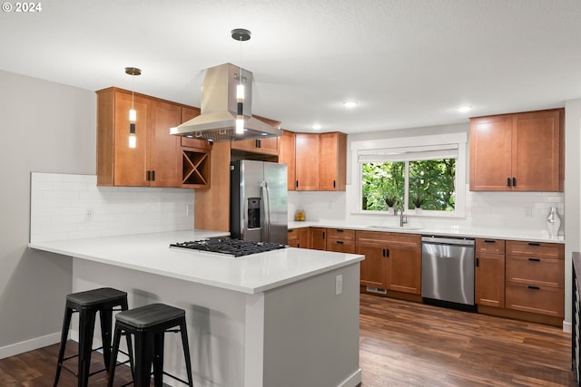 kitchen with dark wood-type flooring, stainless steel appliances, hanging light fixtures, and island exhaust hood