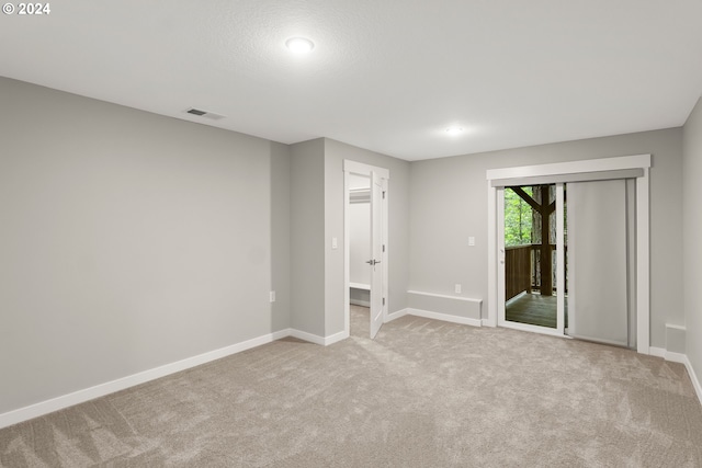 carpeted spare room featuring a textured ceiling