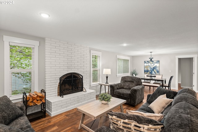 living room featuring a textured ceiling, plenty of natural light, dark hardwood / wood-style flooring, and a fireplace