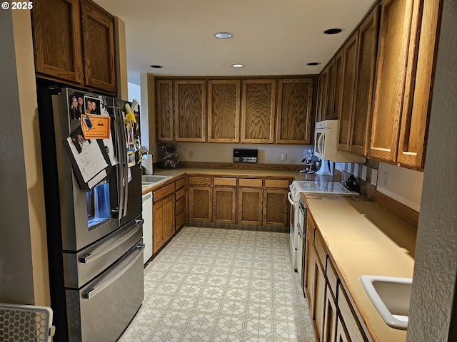 1550 NW Emperor Dr, Corvallis, OR 97330 - kitchen with white appliances, light floors, recessed lighting, light countertops, and a sink