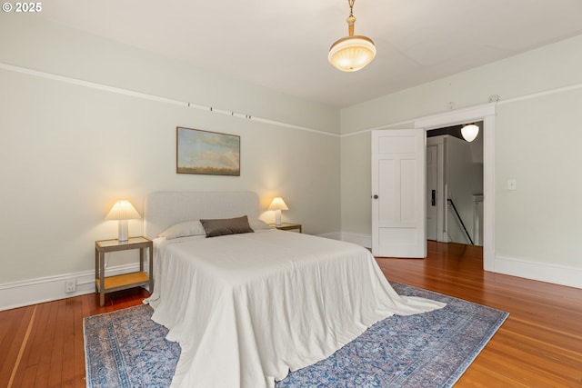 bedroom with wood finished floors and baseboards