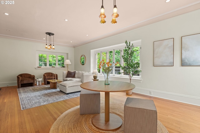 dining room featuring a chandelier, light wood finished floors, baseboards, recessed lighting, and crown molding