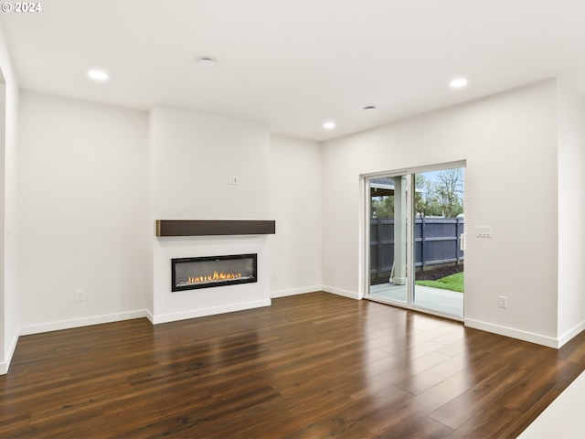 unfurnished living room featuring dark hardwood / wood-style flooring