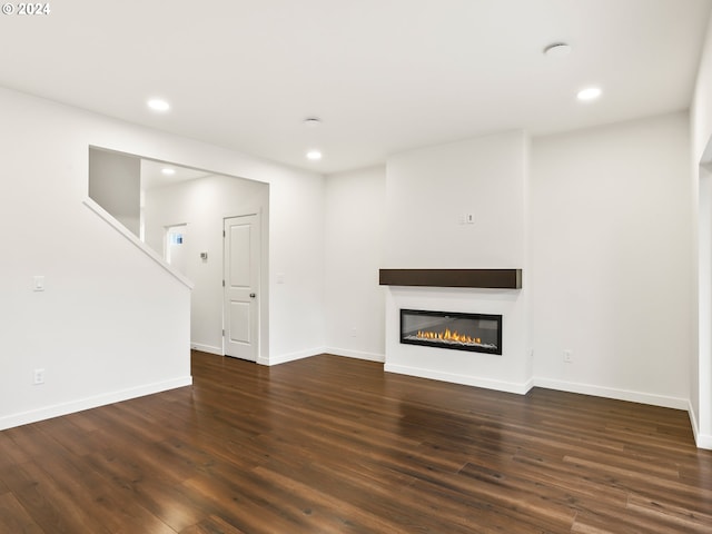 unfurnished living room with dark hardwood / wood-style floors