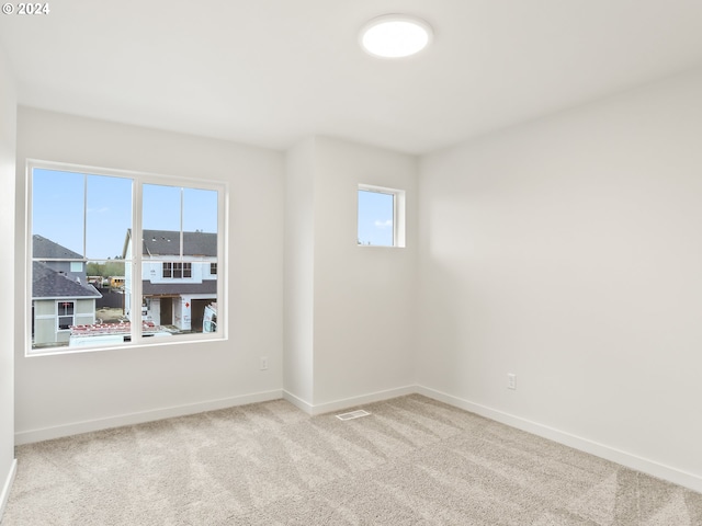 spare room with light colored carpet