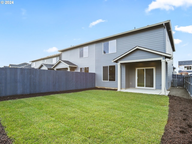 back of property featuring a yard and a patio area