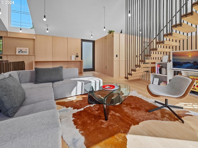 living room featuring a high ceiling and hardwood / wood-style flooring