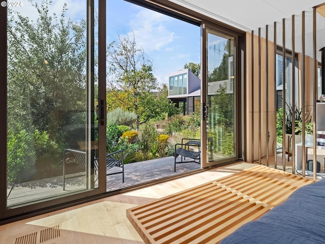 doorway to outside with wood-type flooring