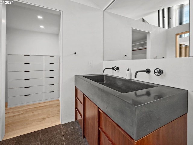 bathroom with hardwood / wood-style flooring and vanity