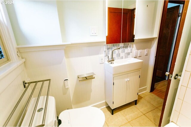 bathroom with tiled shower / bath combo, ornamental molding, tile patterned flooring, and toilet