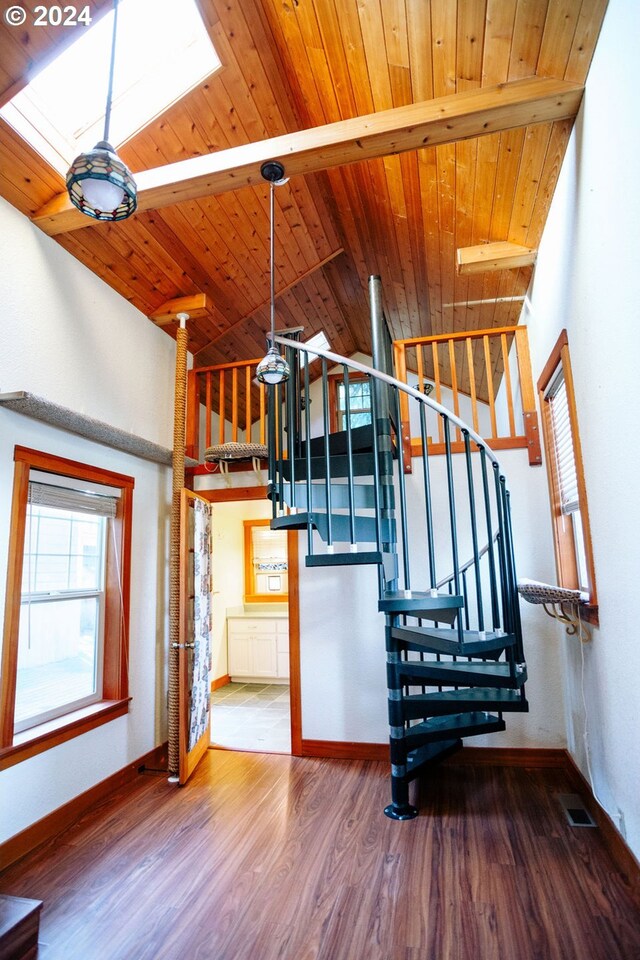 staircase featuring hardwood / wood-style floors, vaulted ceiling, and wooden ceiling