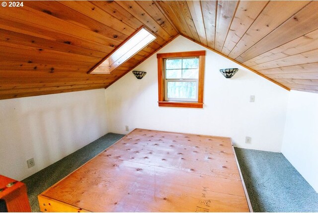 stairway with hardwood / wood-style floors, high vaulted ceiling, a skylight, wooden ceiling, and beam ceiling