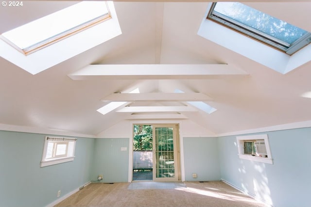 additional living space with lofted ceiling with beams and light carpet