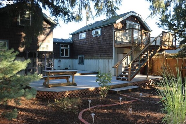 back of house with a deck and stairs