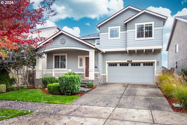 craftsman house with covered porch and a garage