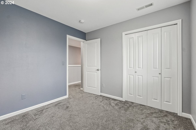 unfurnished bedroom featuring a closet and carpet