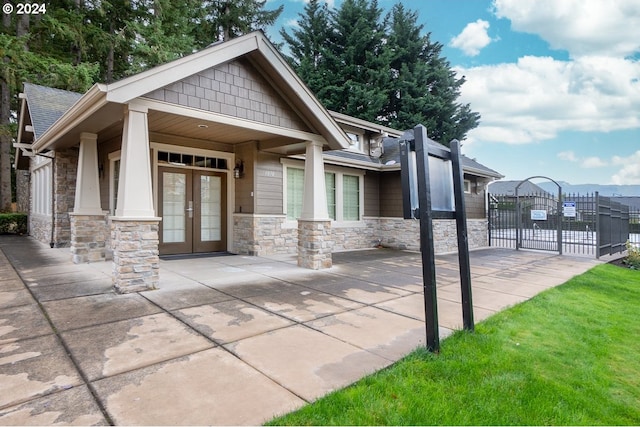 exterior space featuring french doors and a front lawn