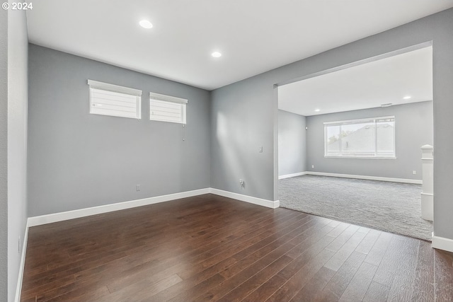 unfurnished room featuring dark wood-type flooring