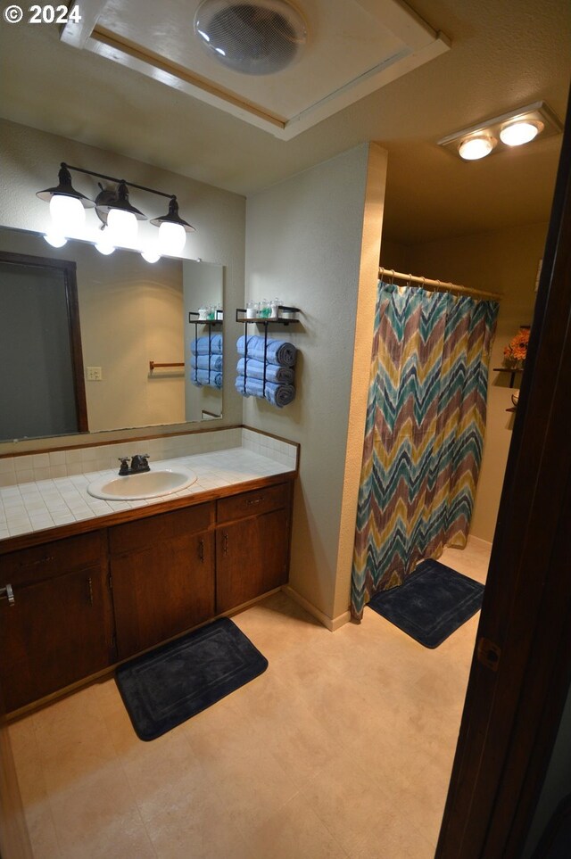 bathroom with vanity and curtained shower