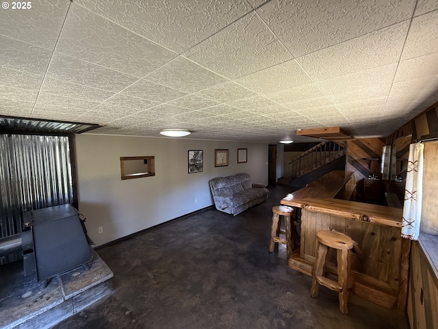 2822 S Tenmile Lk, Lakeside, OR 97449 - interior space with baseboards, stairs, and a wood stove