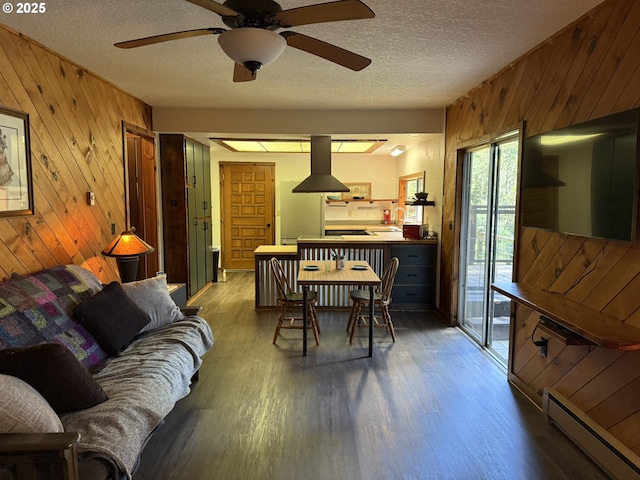 2822 S Tenmile Lk, Lakeside, OR 97449 - dining room with wood finished floors, baseboard heating, wood walls, and a textured ceiling
