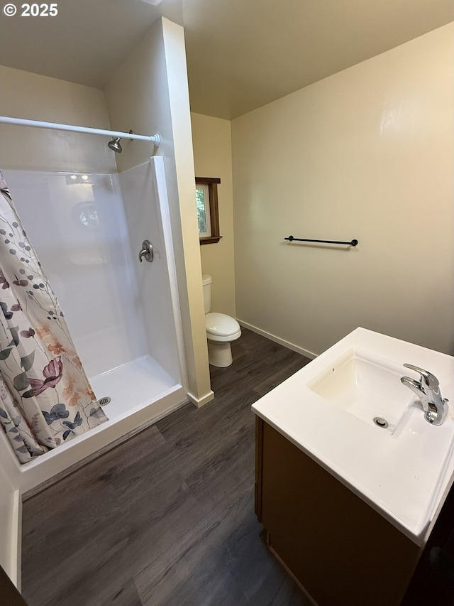 2822 S Tenmile Lk, Lakeside, OR 97449 - full bathroom with wood finished floors, vanity, a shower with curtain, baseboards, and toilet