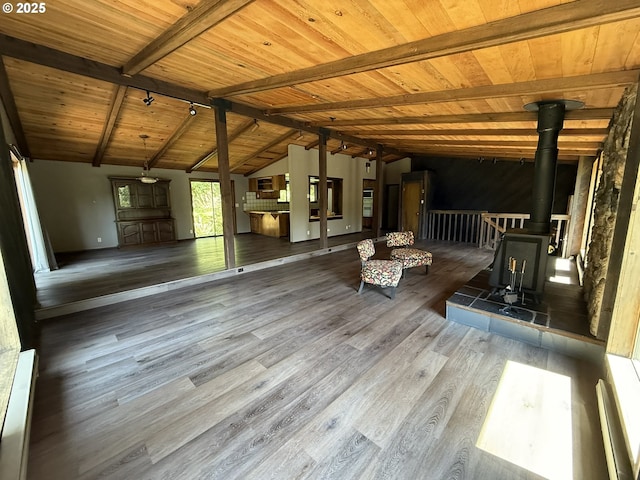 2822 S Tenmile Lk, Lakeside, OR 97449 - unfurnished living room with wood ceiling, vaulted ceiling with beams, wood finished floors, and a wood stove