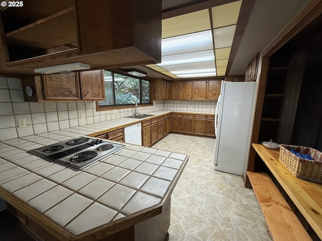 2822 S Tenmile Lk, Lakeside, OR 97449 - kitchen with tasteful backsplash, tile counters, a sink, white appliances, and stone finish floor