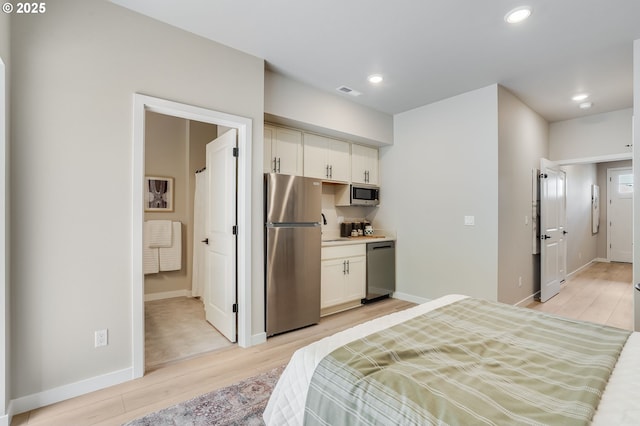 13185 SW Carmel St, Tigard, OR 97224 - bedroom featuring freestanding refrigerator, light wood-type flooring, baseboards, and recessed lighting