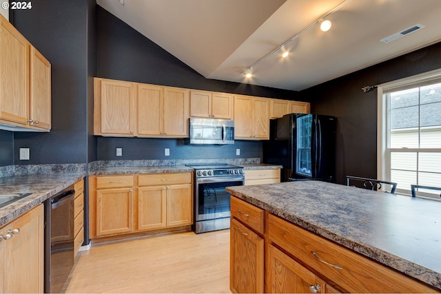 kitchen featuring light brown cabinets, stainless steel appliances, light hardwood / wood-style flooring, and lofted ceiling