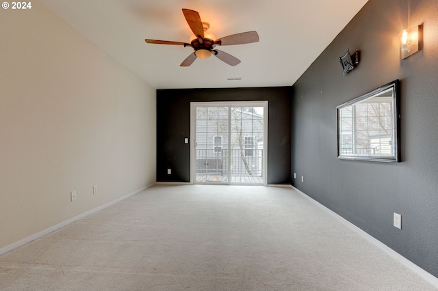 unfurnished room featuring ceiling fan, light carpet, and a wealth of natural light