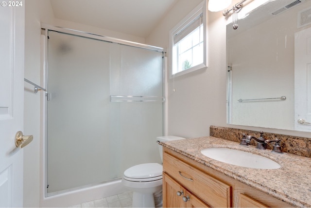 bathroom featuring toilet, an enclosed shower, and vanity