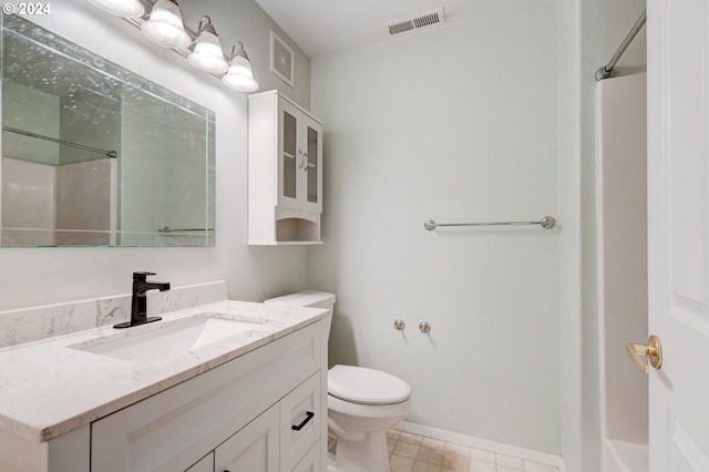 bathroom with a shower, vanity, and toilet