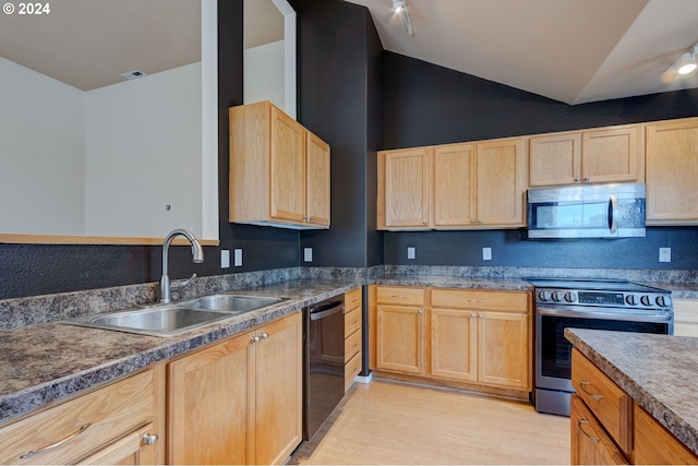 kitchen featuring light brown cabinets, sink, vaulted ceiling, light wood-type flooring, and stainless steel appliances