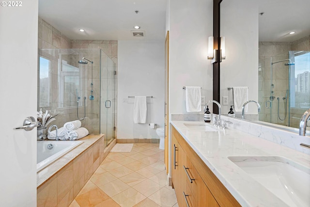 full bathroom with shower with separate bathtub, double sink vanity, tile patterned flooring, and toilet