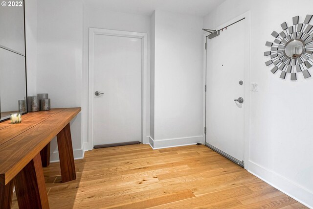 hallway with light hardwood / wood-style flooring