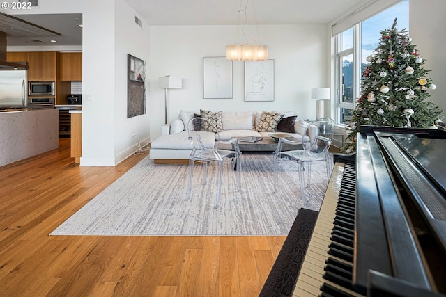 living room featuring a notable chandelier and light hardwood / wood-style floors