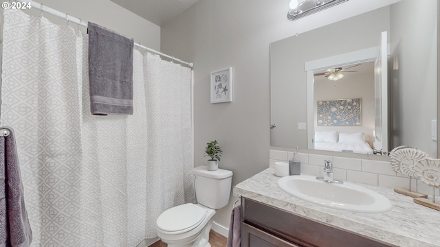 bathroom with ceiling fan, vanity, and toilet