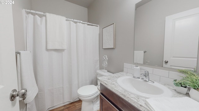 bathroom featuring a shower with shower curtain, vanity, toilet, and hardwood / wood-style flooring