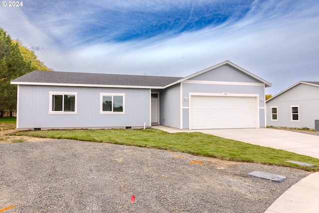 single story home with a garage and a front yard