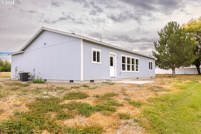 rear view of house featuring cooling unit and a patio area