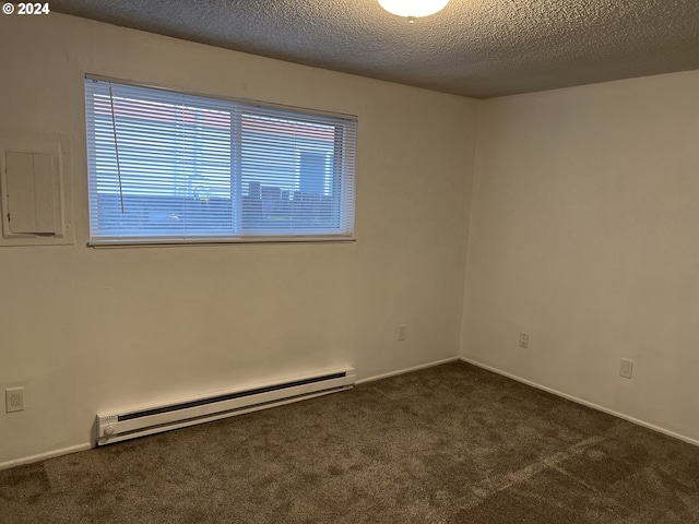 carpeted empty room with a textured ceiling, electric panel, and a baseboard radiator