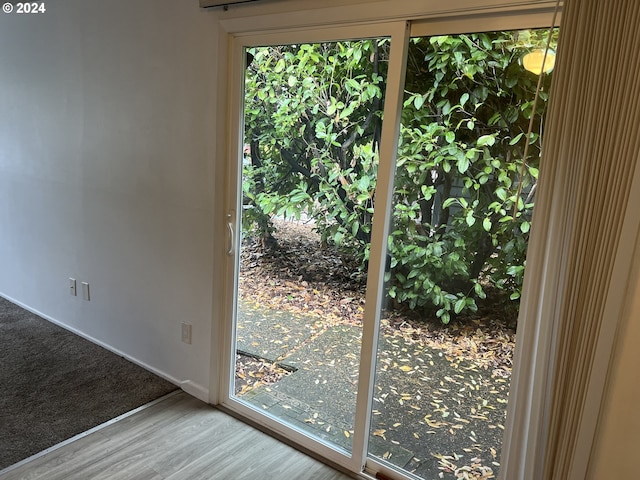 doorway to outside featuring plenty of natural light and hardwood / wood-style flooring