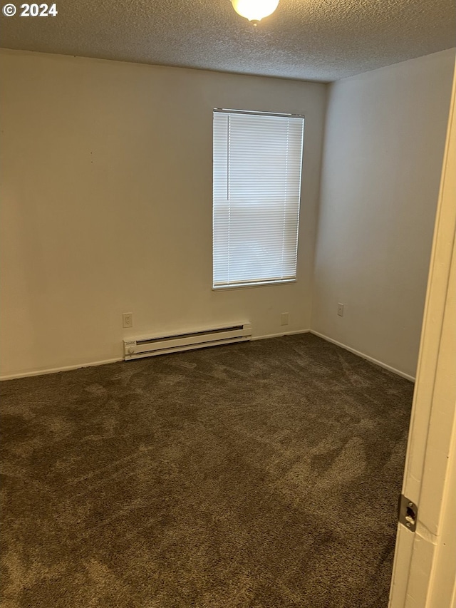 unfurnished room with a textured ceiling, baseboard heating, and dark colored carpet