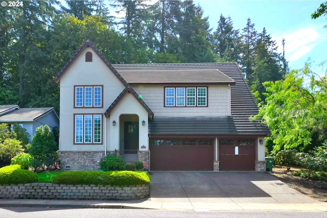 view of front of property with concrete driveway, a garage, and stone siding