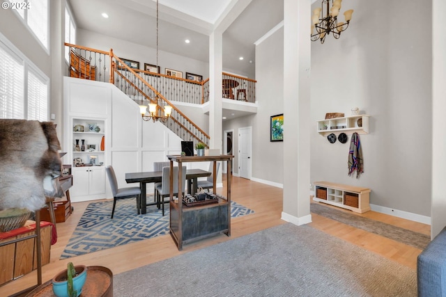 sitting room featuring a high ceiling, hardwood / wood-style floors, and an inviting chandelier