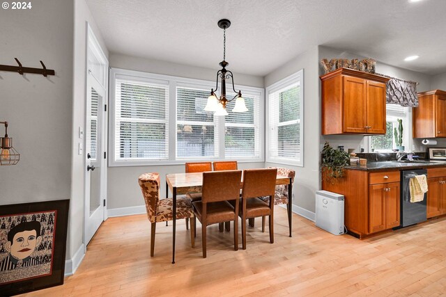 kitchen with hanging light fixtures, dishwasher, light hardwood / wood-style floors, a chandelier, and a textured ceiling