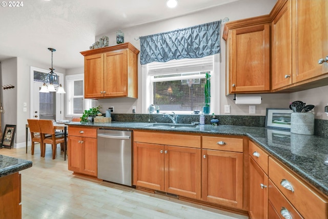 kitchen featuring hanging light fixtures, dark stone countertops, light hardwood / wood-style floors, sink, and stainless steel dishwasher